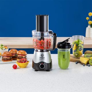 Magic Bullet food processor on a cream kitchen counter surrounded with food