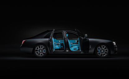 Rolls-Royce with open doors against dark background