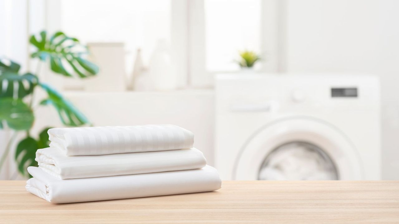 White folded fitted sheets on a tabletop 