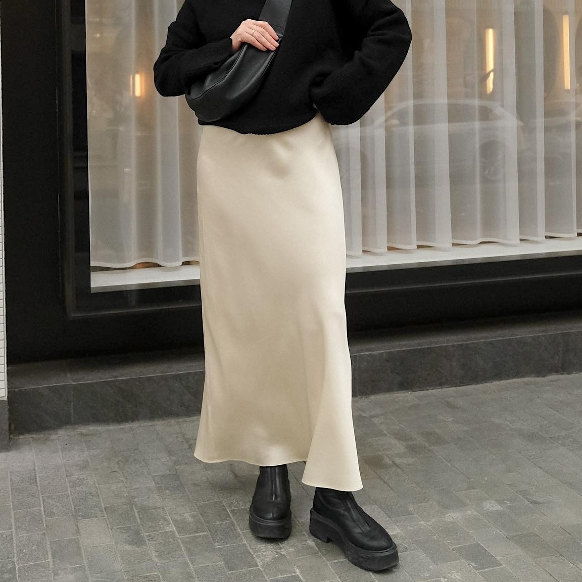 British style influencer Francesca Saffari wearing a chic fall and winter 2025 outfit with black The Row zipped boots