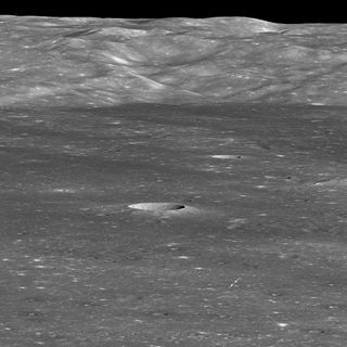Arrows indicate the position of China’s Chang'e 4 lander on the floor of Von Kármán Crater in this image captured by NASA’s Lunar Reconnaissance Orbiter (LRO) on Jan. 30, 2019. The sharp crater behind and to the left of the landing site is 12,800 feet (3,900 meters) wide and 1,970 feet (600 m) deep.