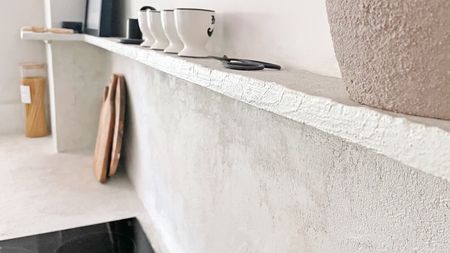 Microcement backsplash and shelf above kitchen hob