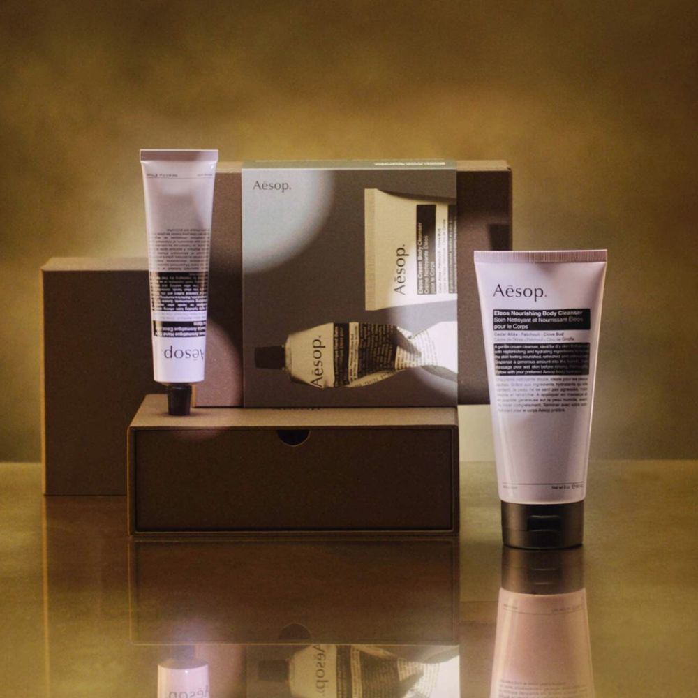 Image of Aesop skincare products on gold box and background.