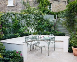 An enclosed garden with a light grey fence