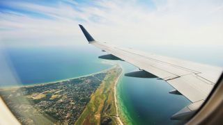 A view from the window of a plane flying over an island