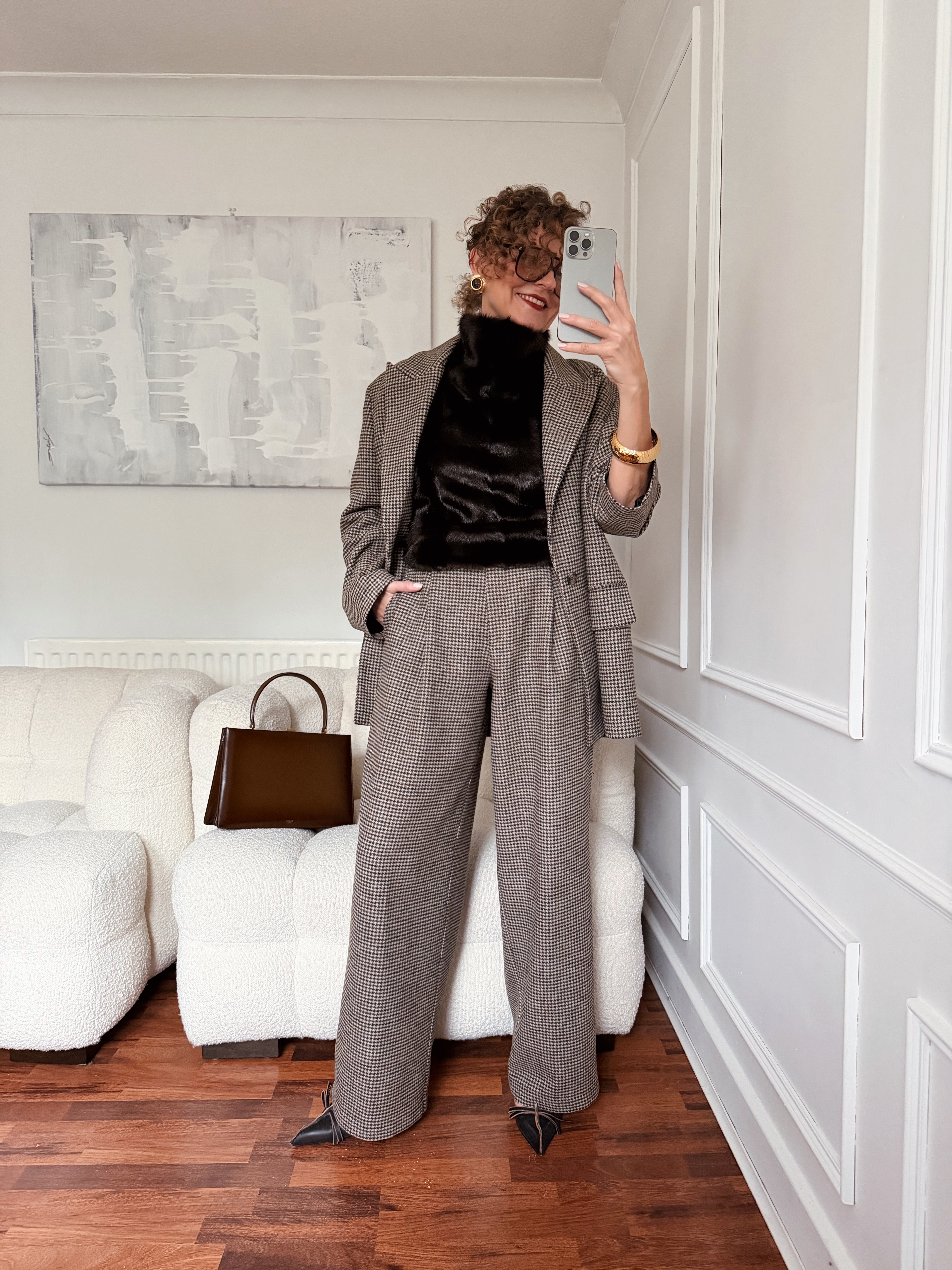 Renia Jazdzyk wearing a work outfit for mature women&amp;mdash;a checked suit and faux fur top.