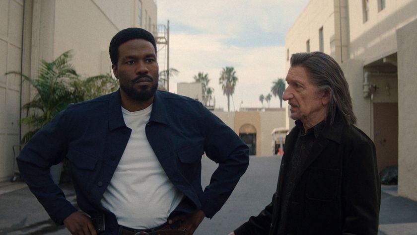 Simon Williams standing with his hands on his hips as Trevor Slattery looks at him in Marvel's Wonder Man