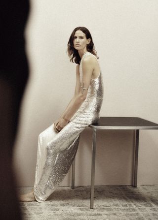 woman in silver slip dress from H&M Studio Holiday Capsule
