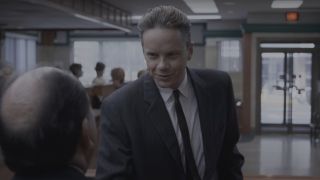 Tim Robbins shakes hands with a bank manager in The Shawshank Redemption.