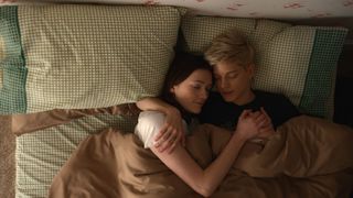 Charlotte Richie and Mae Martin embrace while laying in bed in 'Feel Good'