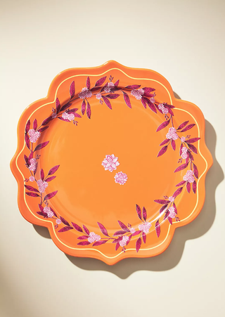 orange patterned plate with pink painted floral detail and a victorian-style shape