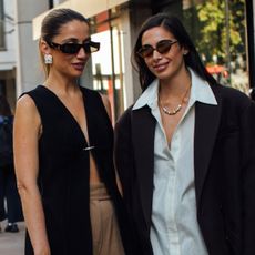 two attendees at london spring fashion week wearing sunglasses