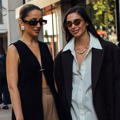 two attendees at london spring fashion week wearing sunglasses