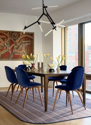 a modern dining table with blue chairs