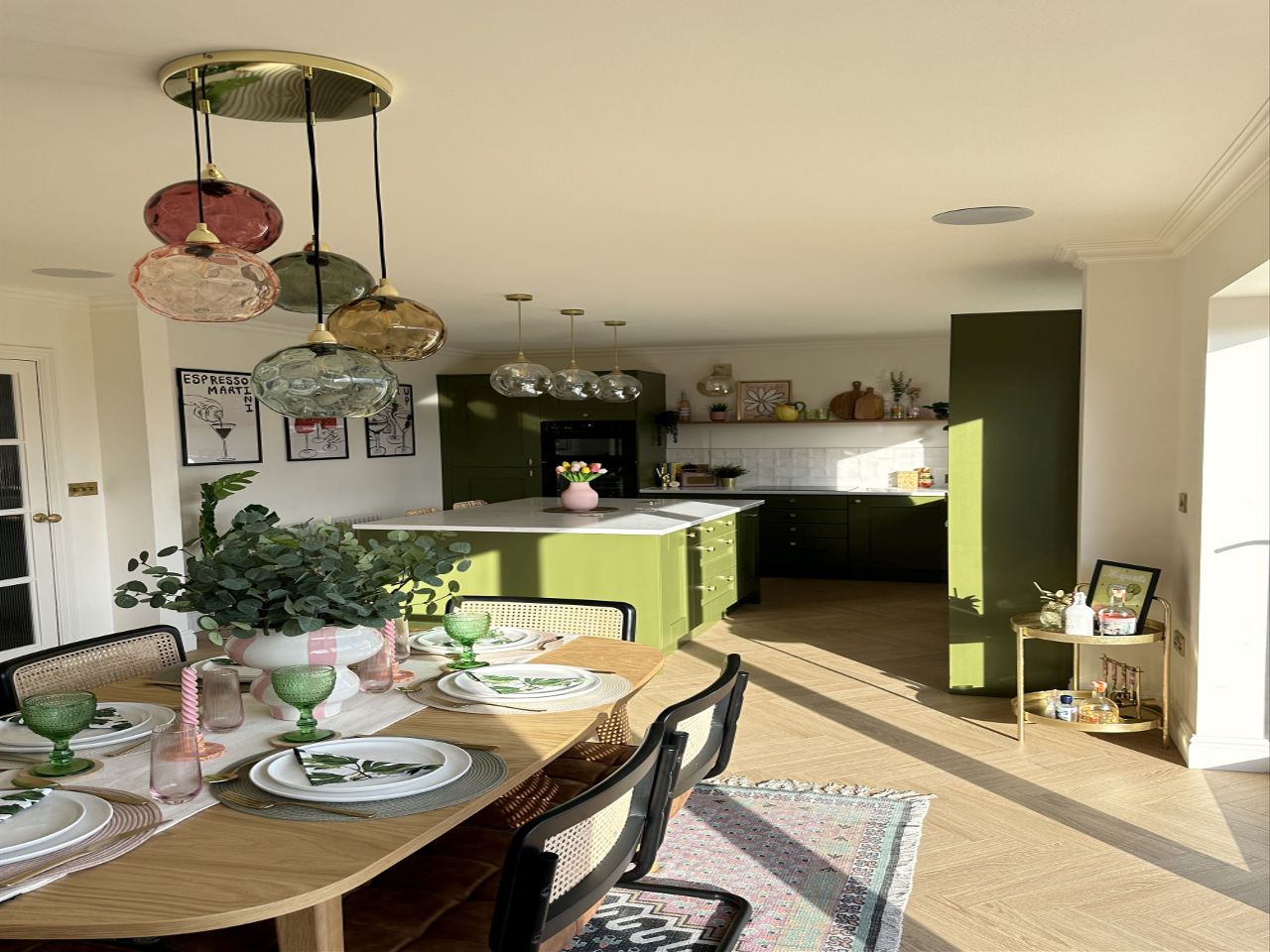 A green kitchen that has been newly decorated