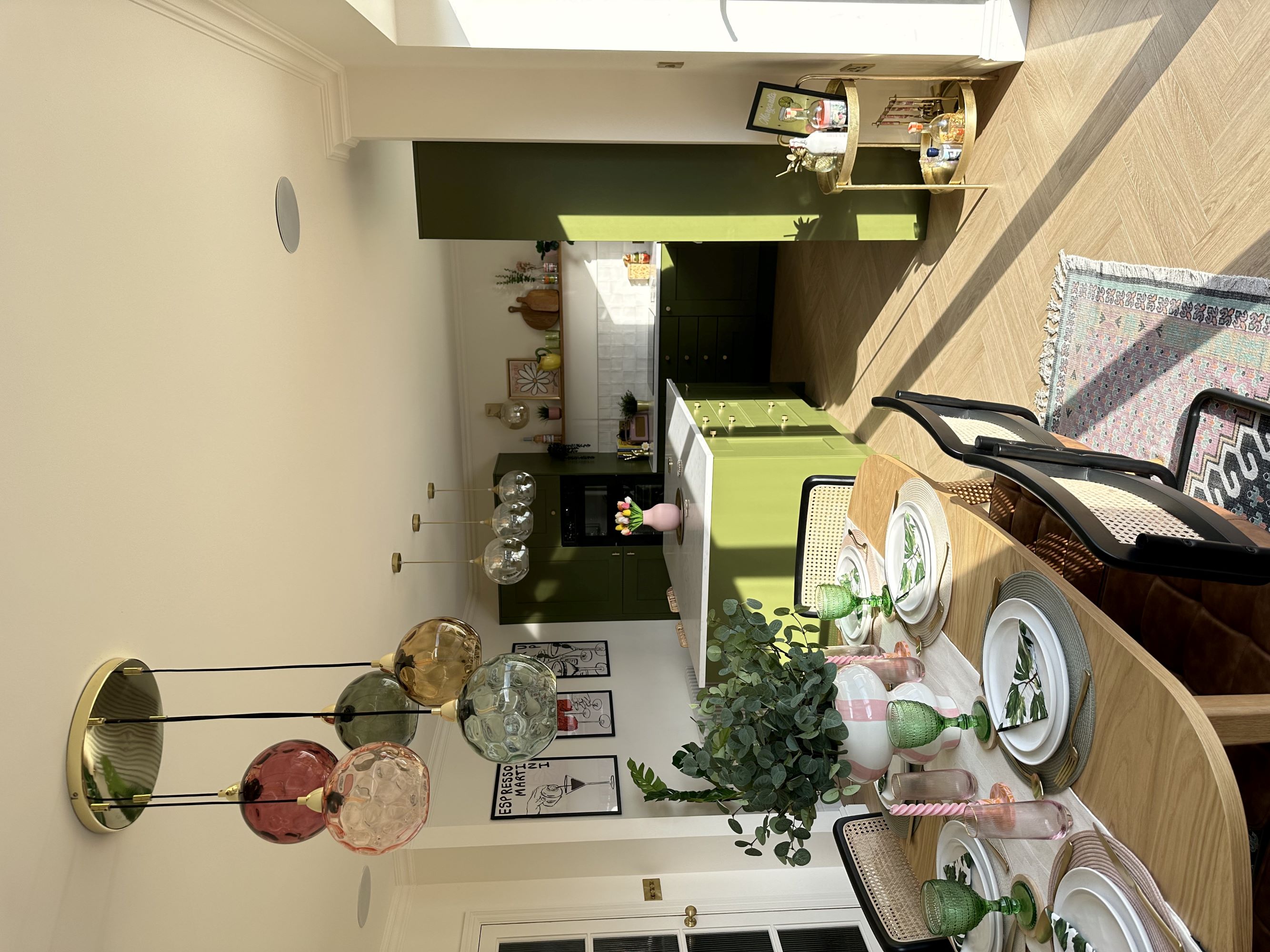 A green kitchen that has been newly decorated