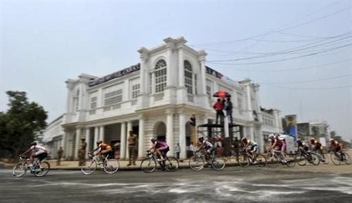 Cyclists ride in a pack past a section of Connaught Place in New Delhi.