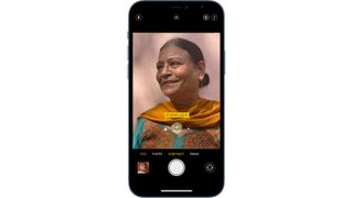 An iPhone being used to capture a photograph in Portrait Mode.