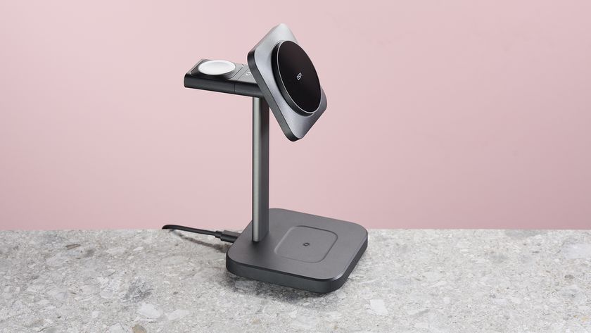 The ESR Qi2 3-in-1 Watch Wireless Charging Set sits facing to the right on a light grey stone surface against a pink background.