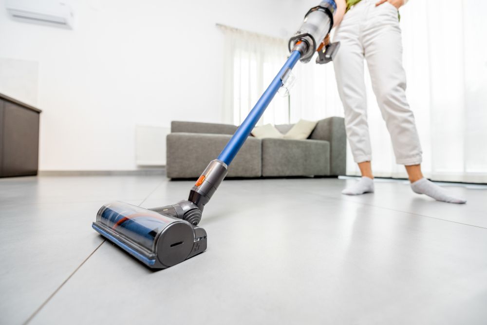 Woman vacuum cleaning floor