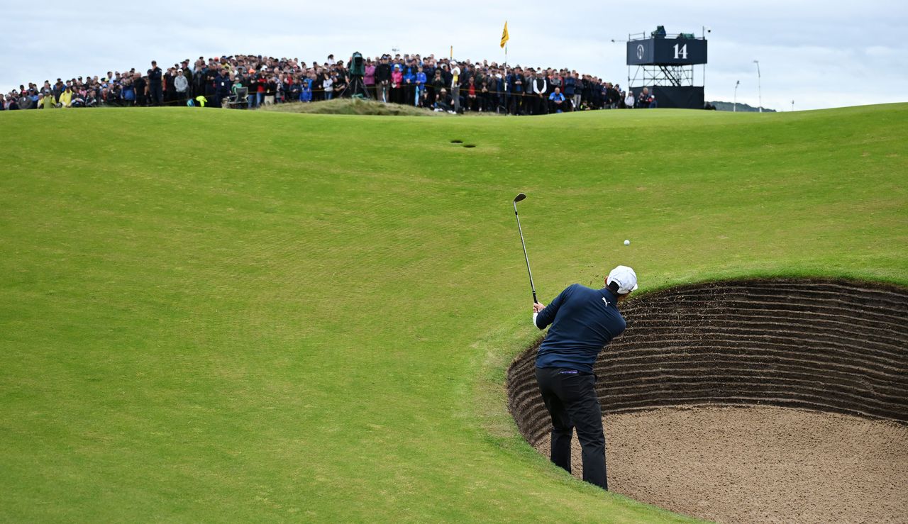 Rickie Fowler plays a bunker shot