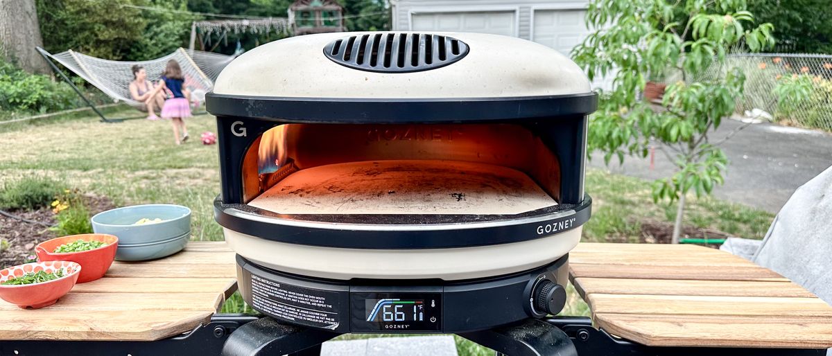 Gozney Arc pizza oven shown outside in a backyard