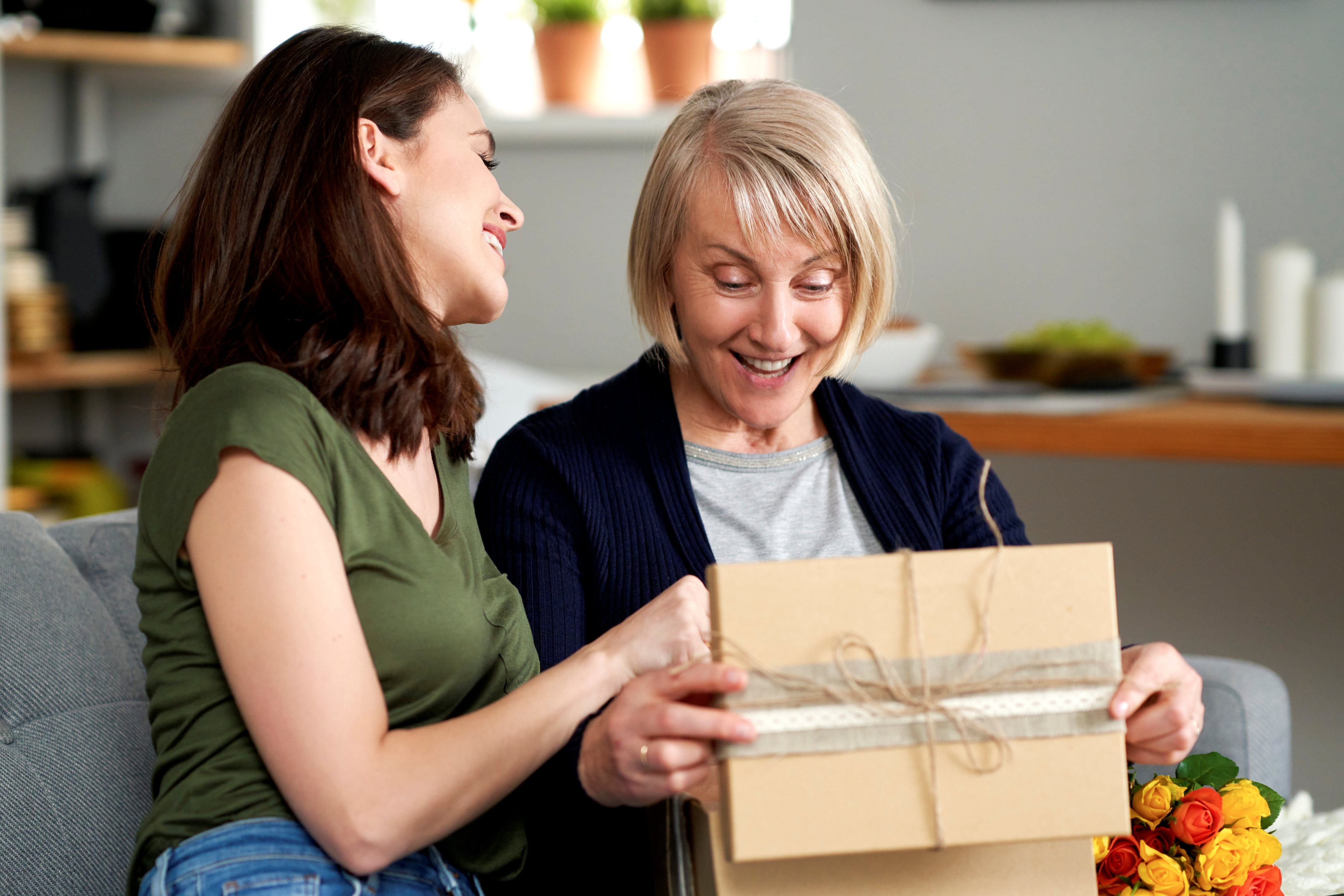 A daughter gives her mother a gift for Mother's Day.