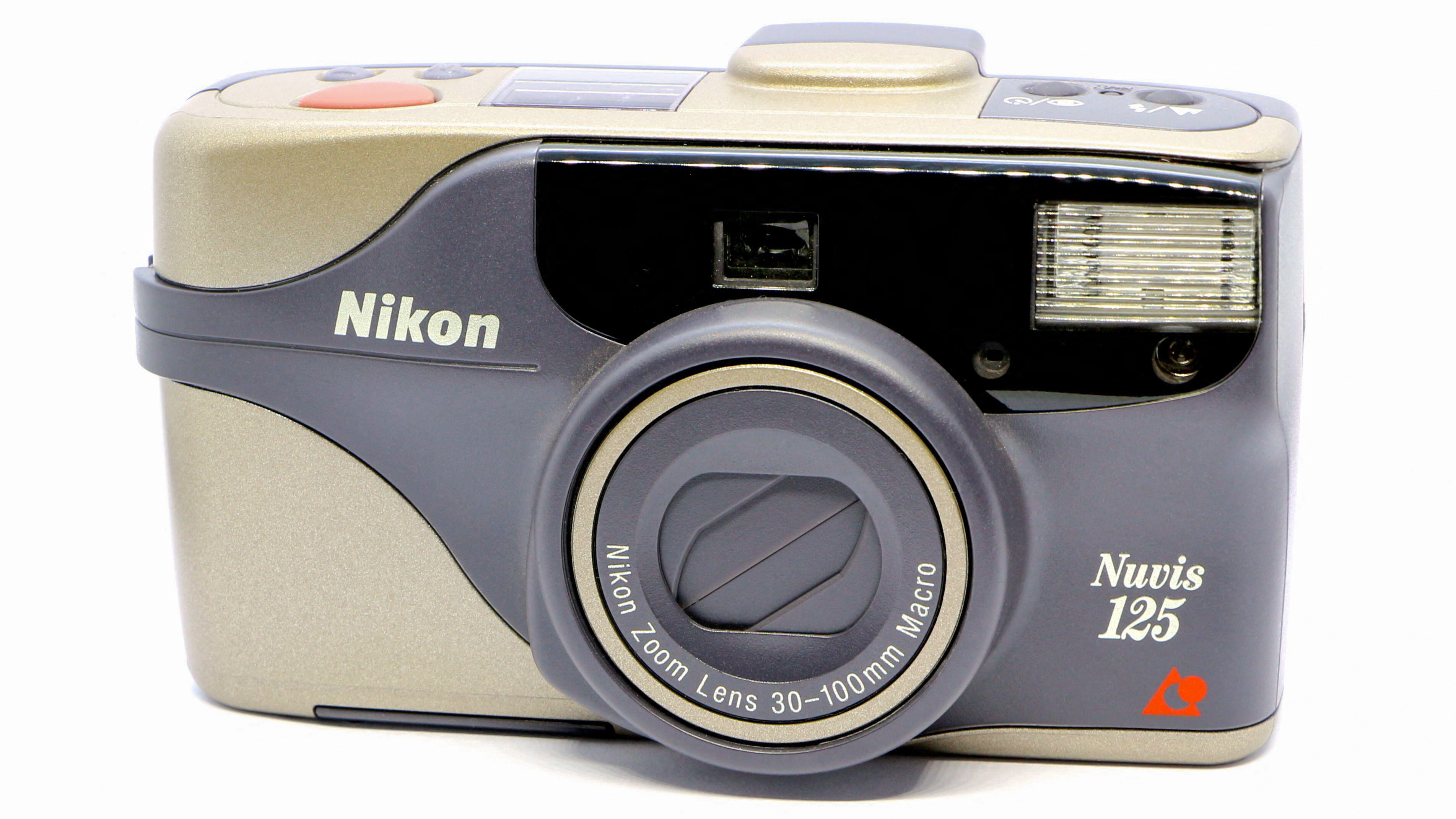 2ECBT74 Photo of an Old used 35mm Nikon Nuvis 125 film camera grey and silver with built in flash with a 30-100 mm zoom lens and macro