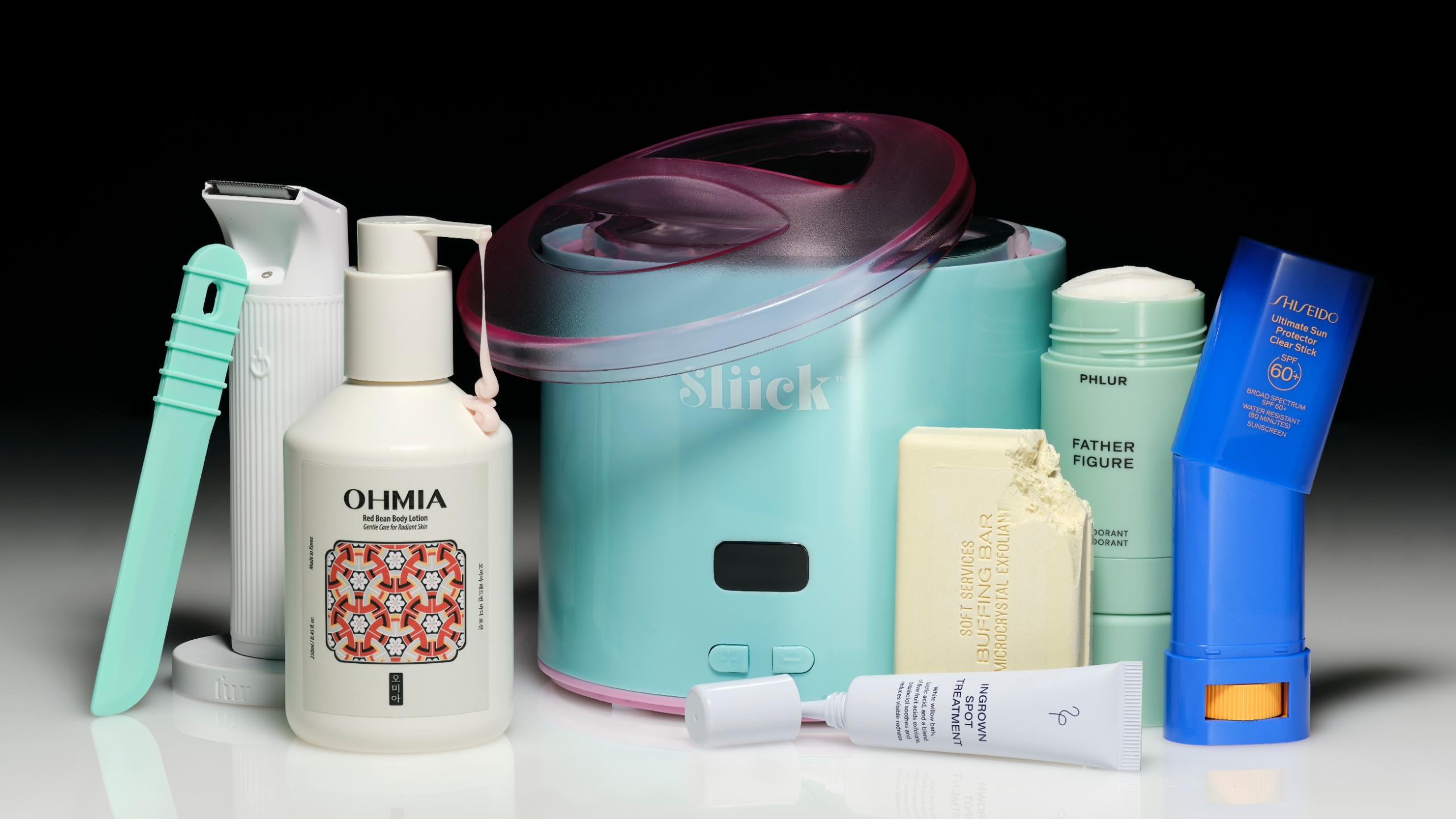 a selection of body care products on a black backdrop on a white ground