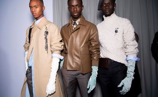 Three male models wearing clothing by Dior in brown shades.