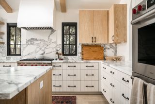 modern kitchen with white cabinets and marble island