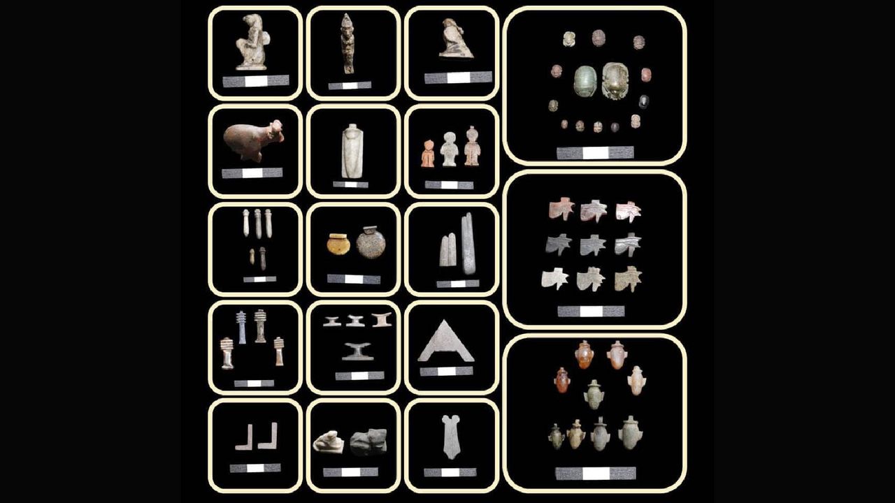 An array of small artifacts made from stone and metal including geometric objects and figurines of people and animals