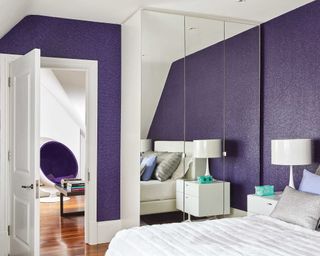 purple and white bedroom with mirrored closet