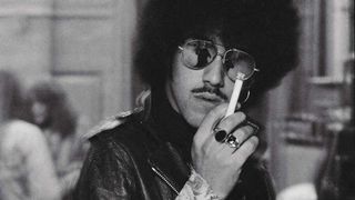 Phil Lynott in sunglasses, smoking a cigarette (1975)