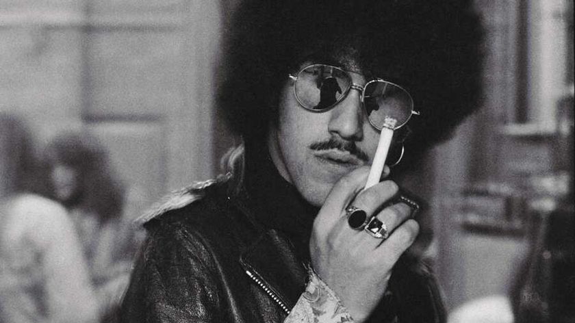 Phil Lynott in sunglasses, smoking a cigarette (1975)