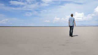 Man standing on empty beach