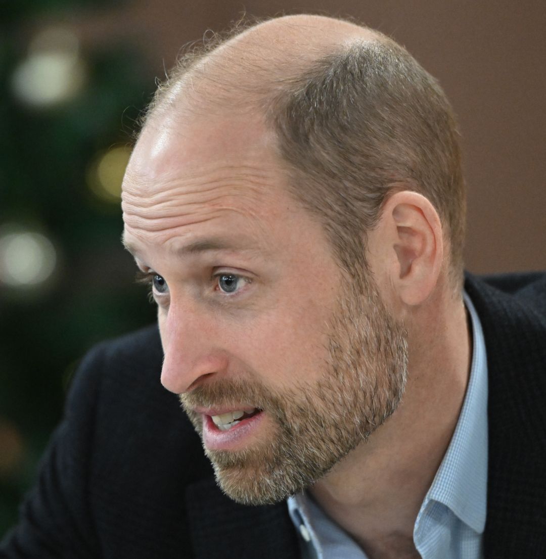 Prince William in front of a Christmas tree