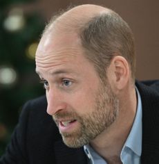 Prince William in front of a Christmas tree