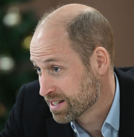 Prince William in front of a Christmas tree