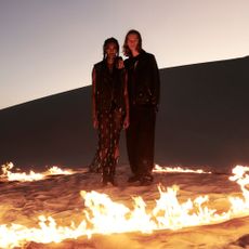 Models wearing AllSaints in front of a fire