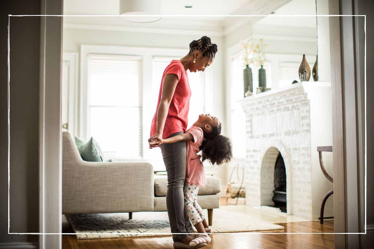 girl standing on mothers feet