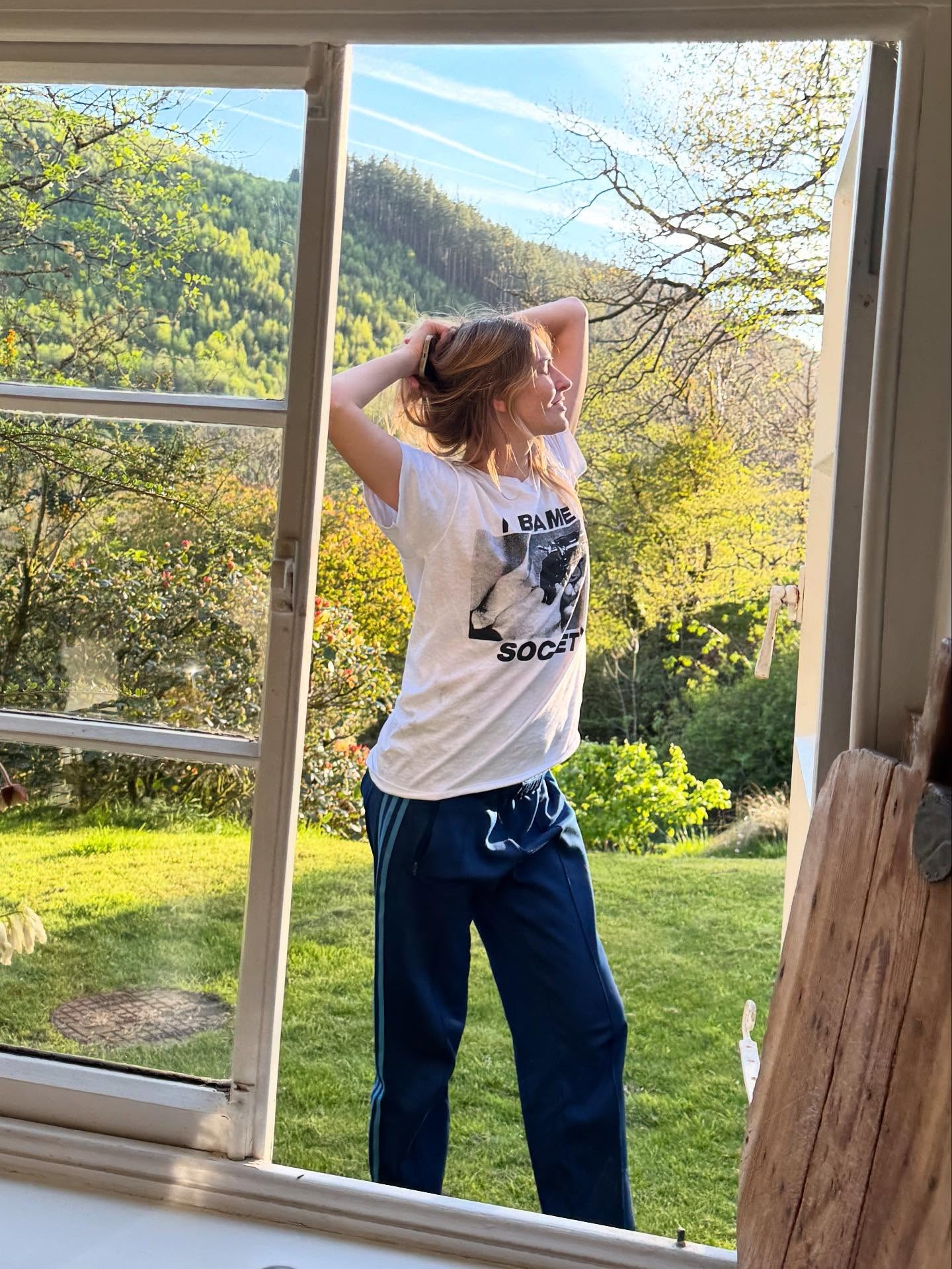 @camillecharriere wearing a graphic T-shirt with sweatpants.