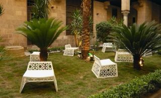 An interior courtyard garden adorned with Karim Mekhtigian’s Soheimi chairs