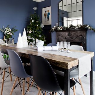 Dining room with blue walls, fireplace and Christmas decorations