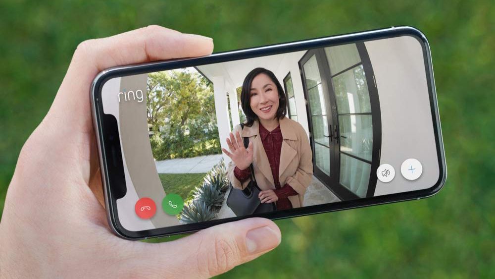 Ring camera feed of a woman waving, being displayed on a phone