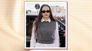 Rosalía wears a grey sweater vest, a white shirt and black sunglasses as she attends the Prada fashion show during the Milan Fashion Week Womenswear Spring/Summer 2024 on September 21, 2023 in Milan, Italy/ in a cream template