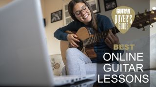 Woman practices guitar in front of her laptop