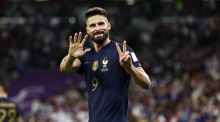 Olivier Giroud signals 52 goals for France after becoming the nation's all-time top scorer with his strike against Poland in the 2022 World Cup in Qatar.