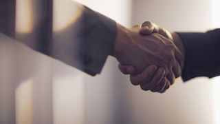 Cisco acquisition: A close up of a handshake denoting a corporate deal