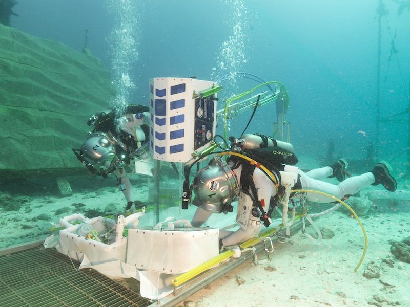 A photo of two aquanauts during a simulated spacewalk.